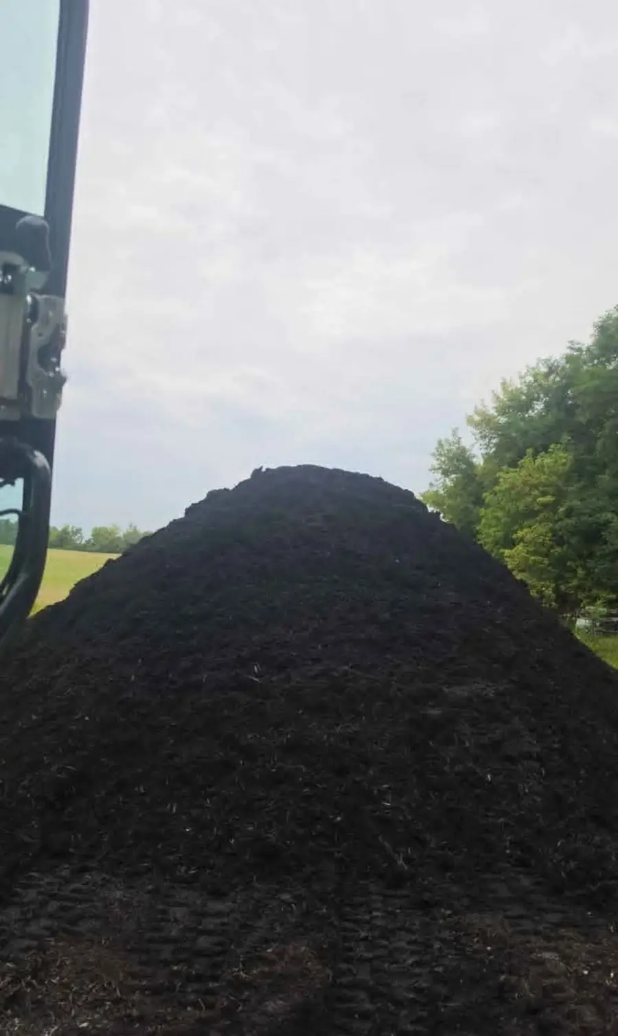 Fresh pile of dark mulch ready to spread